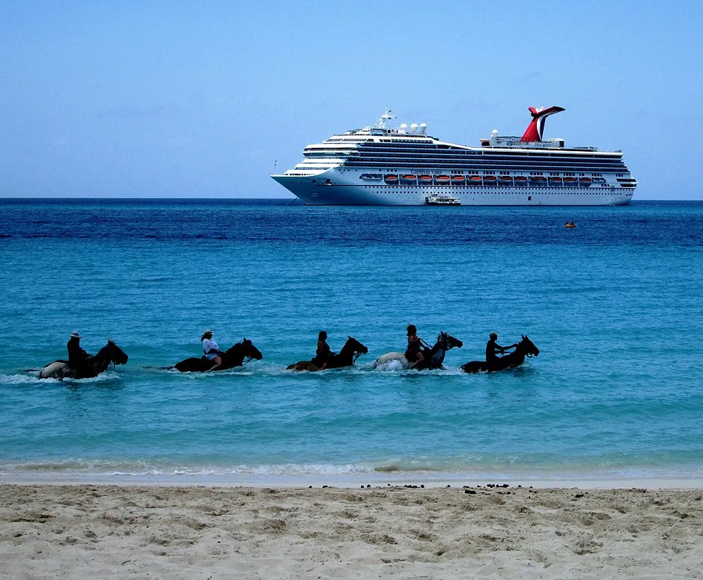 1024px Tourists on horseback in water Half Moon Beach Half Moon Cay with MS Carnival Valor