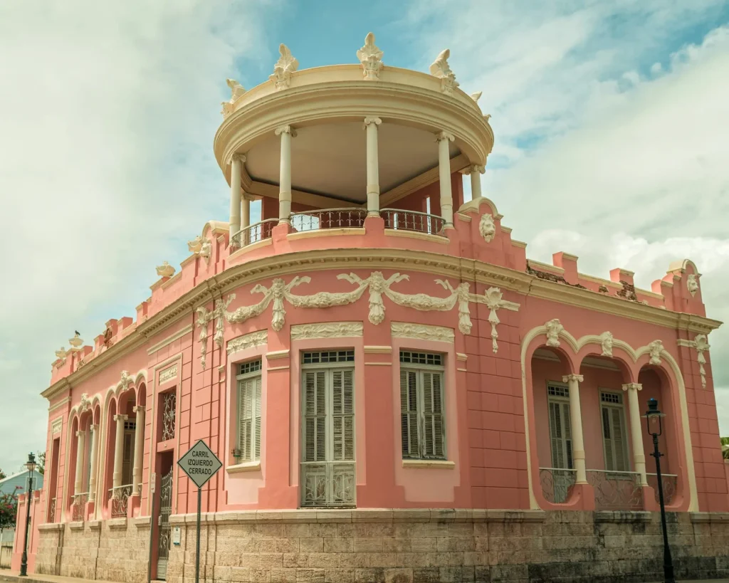 a pink building with a balcony