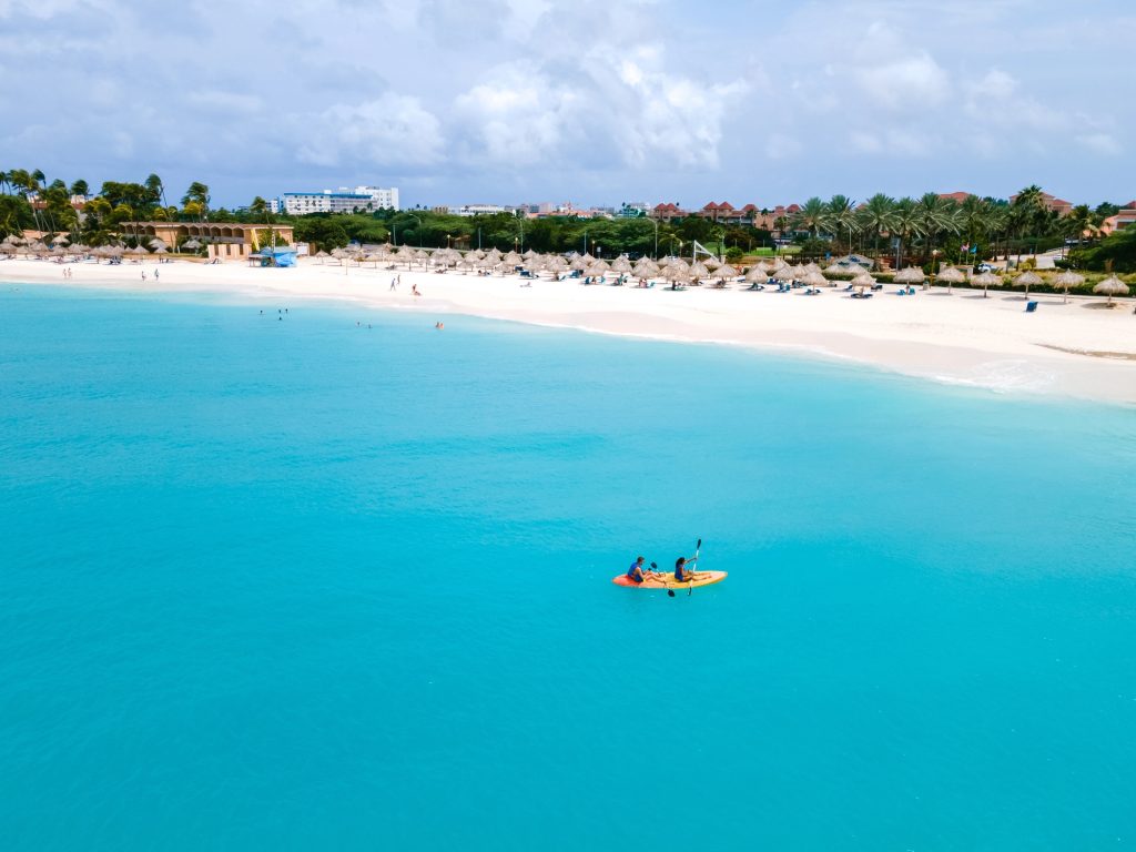 eagle beach aruba couple kayaking